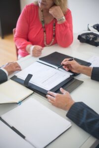 Two businesspeople reviewing documents during a meeting.